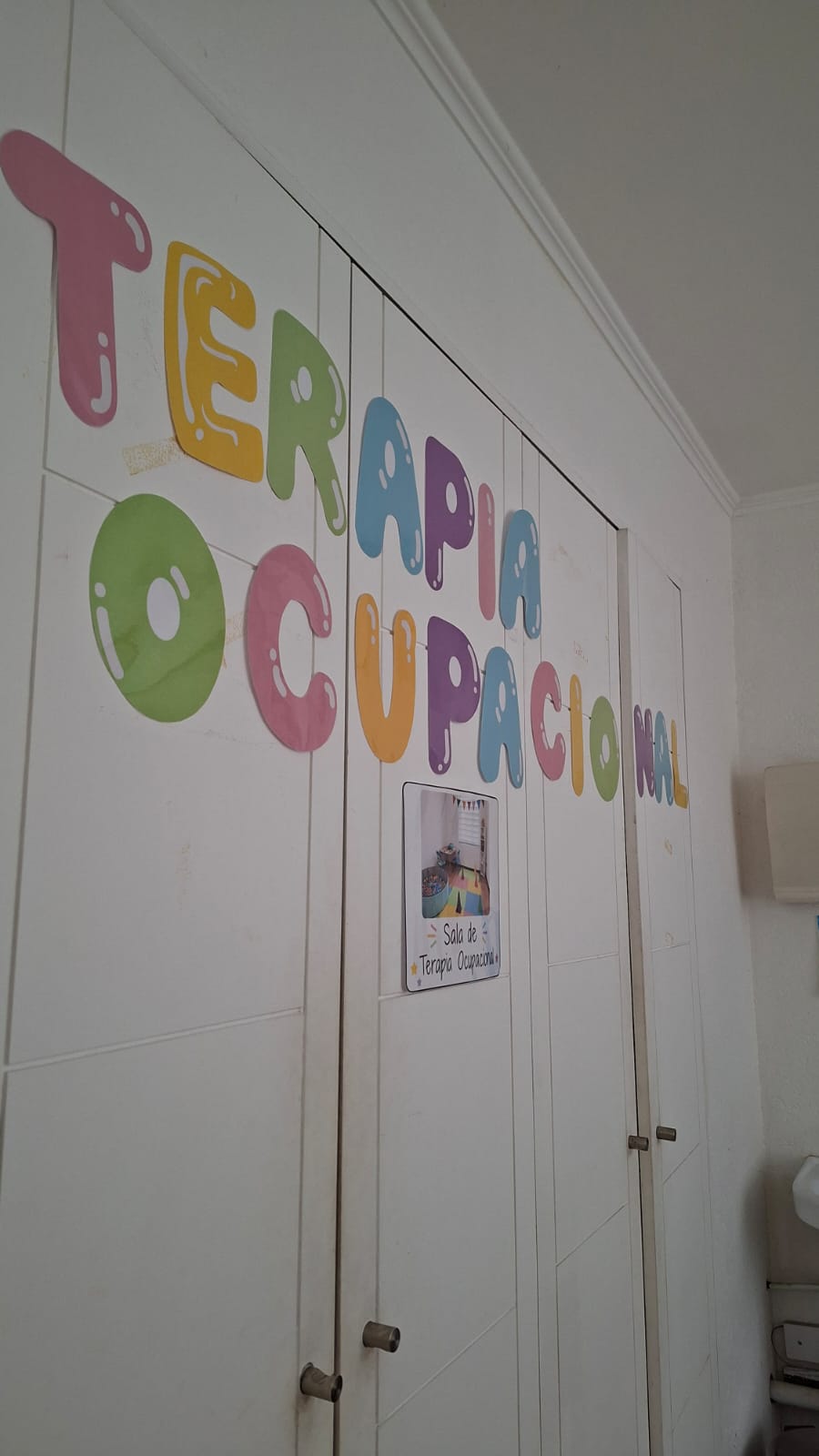 Entrada de la sala de Terapia Ocupacional con un mural colorido.